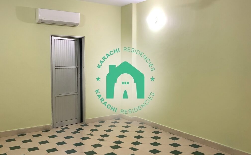 Bright yellow bedroom with AC and grey door - Garden East 3 bed apartment