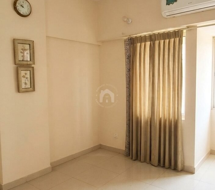 Bedroom with wall clock in 2 bed DD flat for sale in Soldier Bazar, Karachi