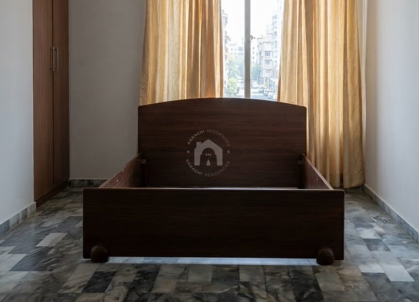 Bedroom with window and curtains in 2 bed DD flat for sale in Soldier Bazar, Karachi