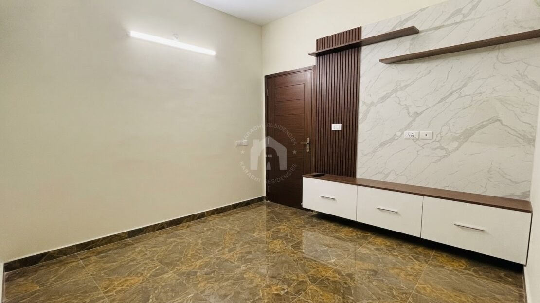 Bedroom with marble accent wall and storage unit in PECHS Block 2 furnished apartment, Karachi Residencies