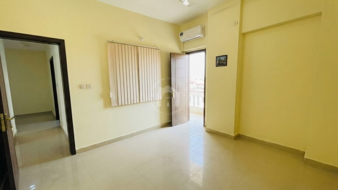 Room with door opening to balcony in PECHS Block 2 furnished apartment, Karachi Residencies